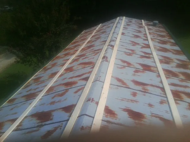 Rusted metal roof panels with new wood purlins before replacement — Storm Damage Roof Repair in Scotland by Roofing Brothers